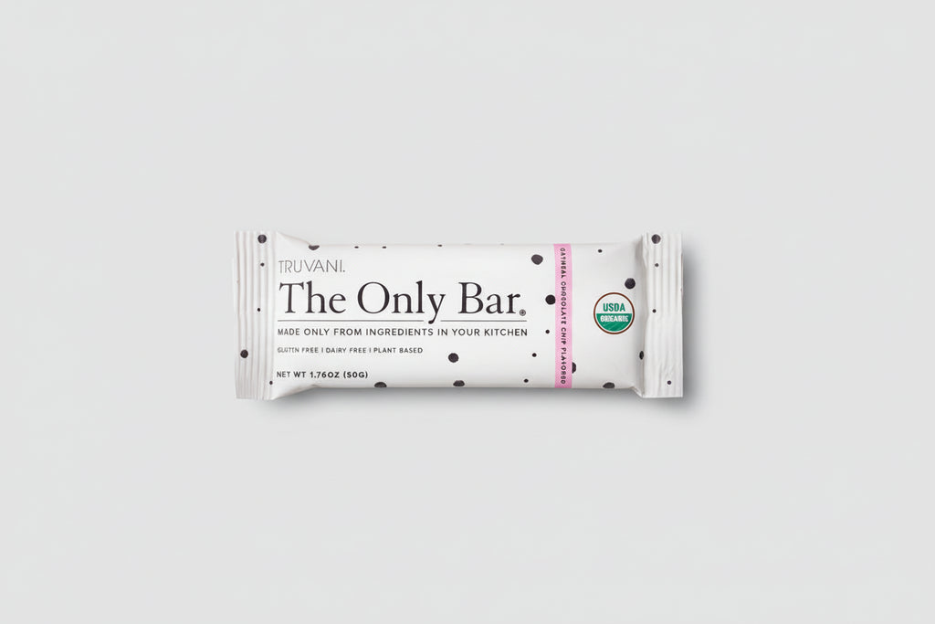 Truvani The Only Bar on a bed of cookies with visible USDA Organic labels.